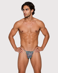Man wearing the Luné d’Or Mirage Men’s G-String in iridescent leopard, front view showing the printed contour pouch.