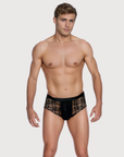 Man wearing the Luné d’Or Veil Lace Brief in black, front view showing the sheer floral lace front.