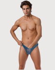 Man wearing the Luné d’Or Lune Lace Thong in blue, front view showing the sheer floral lace front.