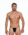 Man wearing the Luné d’Or Fil Men’s G-String in black, front view showing the minimal contour pouch and thin waistband.