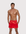 Man wearing the Luné d’Or Men’s Satin Lounge Short in red, front view showing the elastic waistband and side pockets.