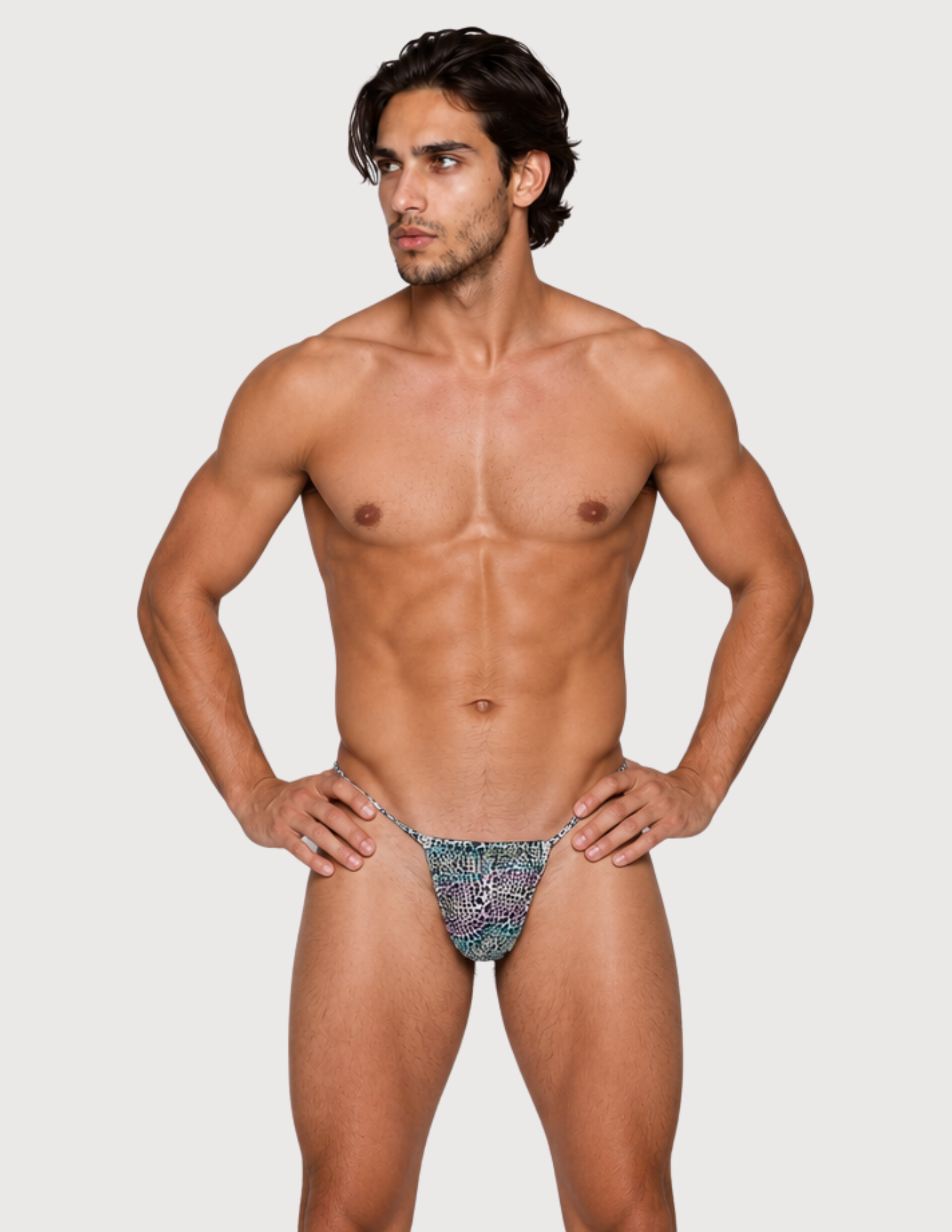 Man wearing the Luné d’Or Mirage Men’s G-String in iridescent leopard, front view showing the printed contour pouch.