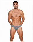 Man wearing the Luné d’Or Mirage Men’s Jockstrap in iridescent leopard print, front view showing the sculpted contour pouch and holographic sheen.