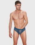 Man wearing the Luné d’Or Veil Lace Brief in blue, front view showing the sheer floral lace front.