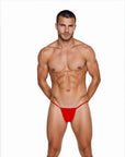 Man wearing the Luné d’Or Fil Men’s G-String in red, front view showing the minimal contour pouch and thin waistband.