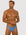 Man wearing the Luné d’Or Forme Men’s Thong in blue, front view showing the contoured pouch and slim waistband.