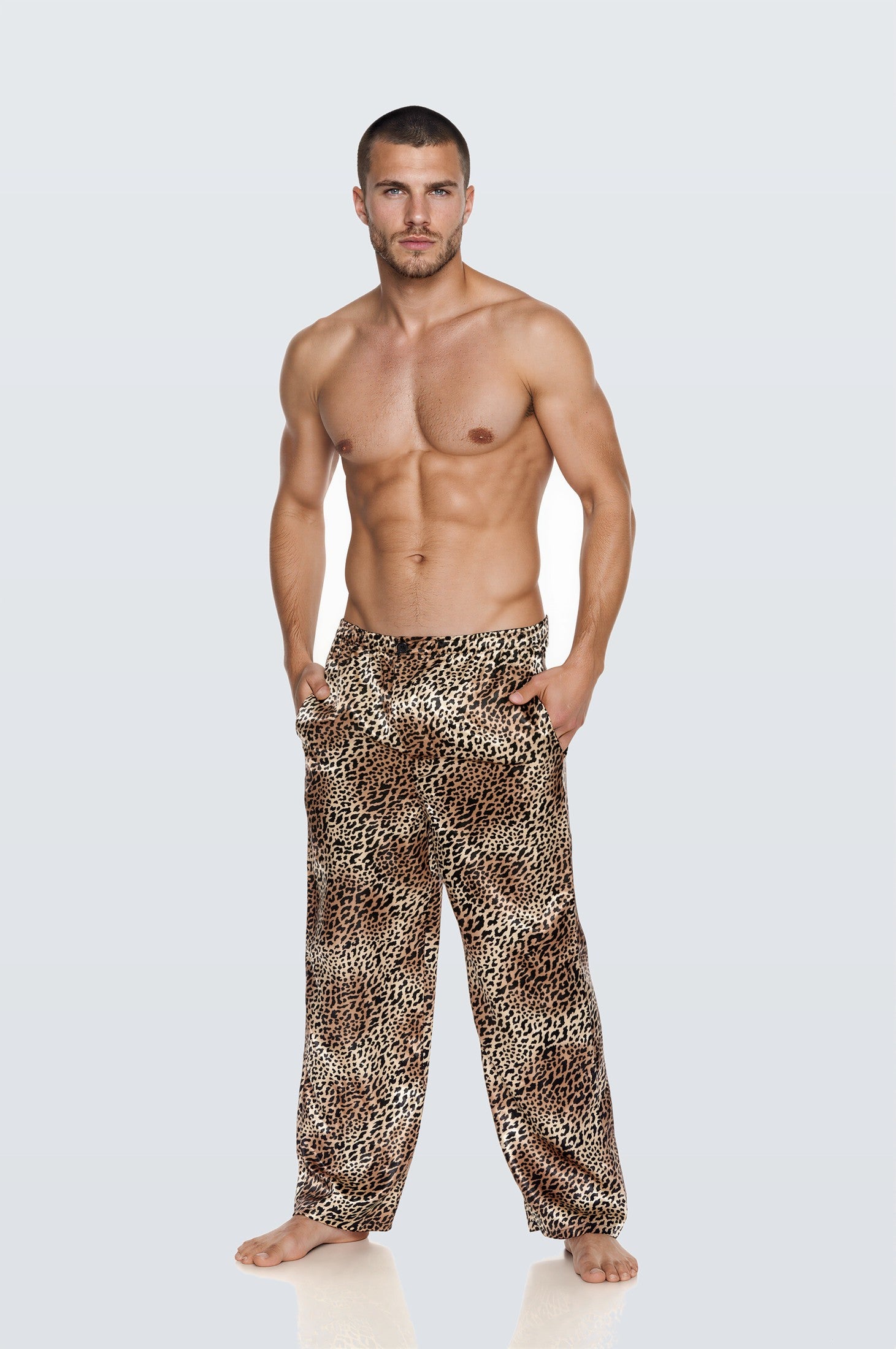 Man wearing the Luné d’Or Men’s Satin Lounge Pant in leopard print, front view showing the elastic waistband and wide straight leg.