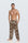 Man wearing the Luné d’Or Men’s Satin Lounge Pant in leopard print, front view showing the elastic waistband and wide straight leg.